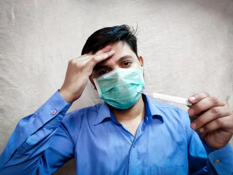 Man checking temporary using Thermometer Stock Photos
