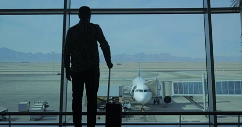 Man checking the time to go boarding on his flight at the airport Stock Footage 299093920
