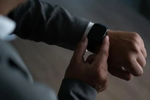 Man checking time on his smartwatch device Close-up display clock checking .. Fotos Stock