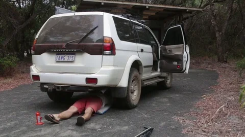 Man checking the underbody of a vehicle Stock Footage 70766880