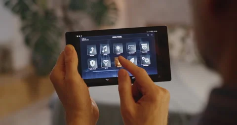 Man checking various functions on home hub 動画素材 130852012