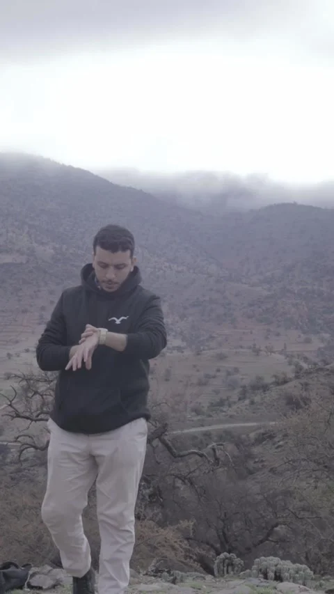 Man Checking Watch on Misty Mountain, Ait Issafen, Morocco Stock Footage 332772882