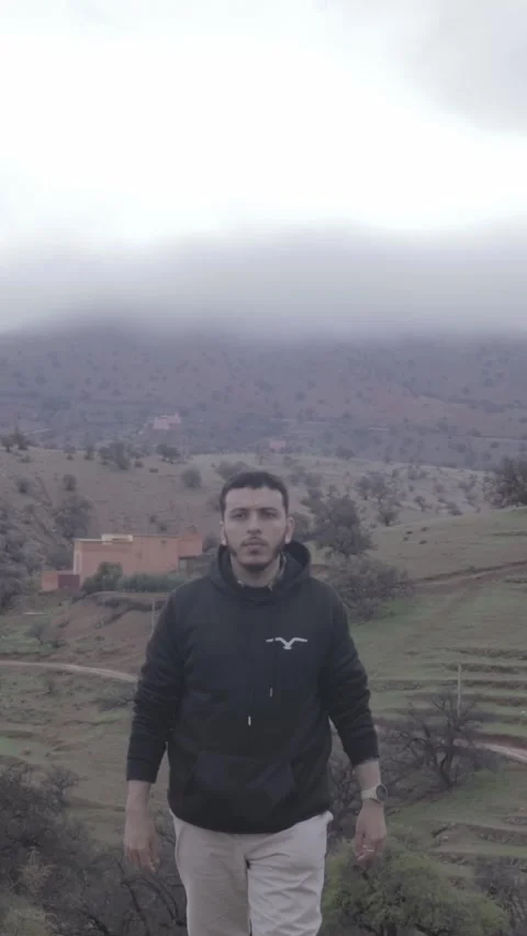 Man Checking Watch on Misty Mountain, Ait Issafen, Morocco 動画素材 332772988