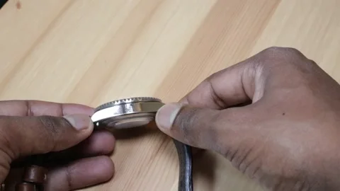 Man checking watch side for scratches Stock Footage 133179453