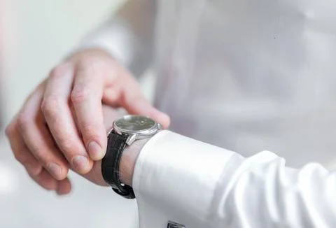 Man Checking Watch on Wrist While Wearing White Long-Sleeved Shirt. Weddig .. Stock Photos