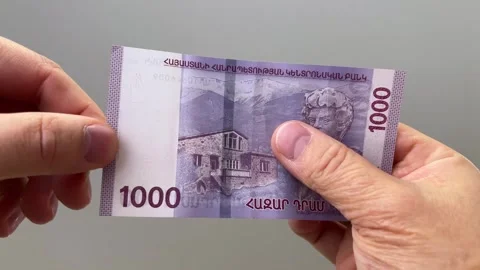 Man checking watermark on 1000 dram banknote Video stock 304360385