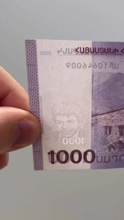 Man checking watermark on 1000 dram banknote Stock Footage 306262760