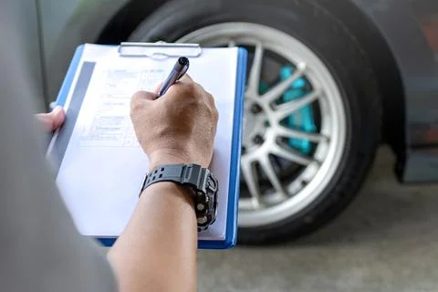 A man checklist in service cycle check of car and check tire air pressure d.. Stock-Fotos