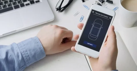 Man checks car information on his mobile device. Good condition. Car remote Stock Footage 78497931