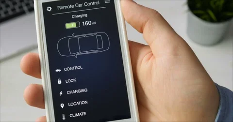 Man checks charge level of his car. Charging in progress Car remote control Stock Footage 78517908