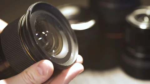 A man checks the cleanliness of the camera lens after cleaning Stock Footage 126536441
