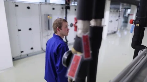 A man checks heating and ventilation systems on the technical floor 動画素材 71244444