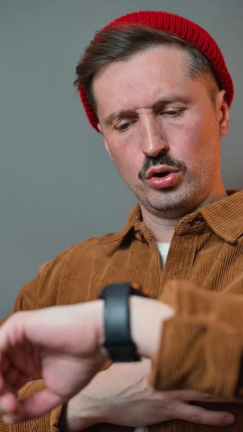 A man checks his smartwatch on his wrist and reacts to notifications with 库存影片 337643161