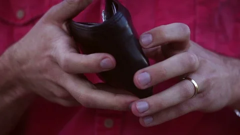 Man checks his wallet and sees that he is broke or bankrupt Stock Footage