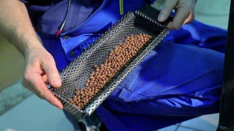 Man checks the quality of coffee roasting. Slow-motion. Stock Footage 72707664