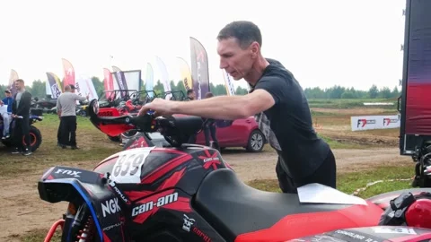 A man checks the technical condition of the ATV quad bike Stock Footage 189047079