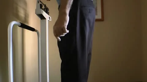 Man Checks Weight On Medical Scale Stock Footage