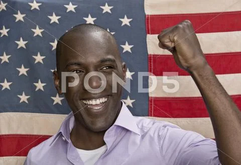 Man cheering in front of American flag Stock-Fotos