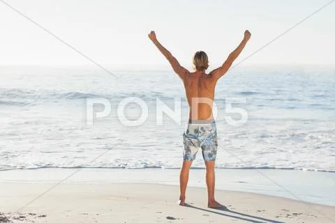 Man cheering looking out to the sea Stock Photos