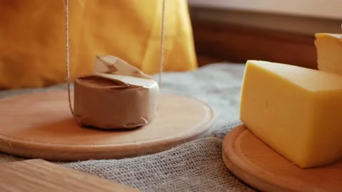 Man cheesemaker wraps cheese in craft paper, packs for sale, buyer. Gift Stock Footage 164668593