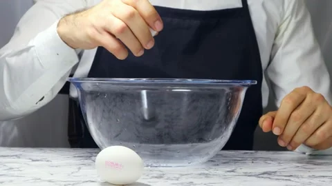 Man Chef Breaking An Egg Into A Bowl  스톡 동영상 182550297