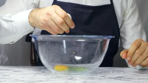 Man Chef Breaking An Egg Into A Bowl Stock-Footage 182556776
