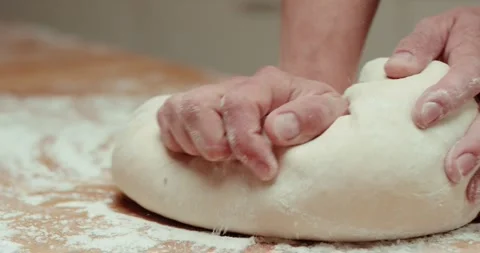 Man chef prepares the dough for baking bread. Close up. Stock Footage 258108999