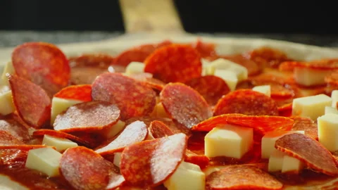 Man chef prepares pizza arranging salami slices evenly Stock Footage 326371258