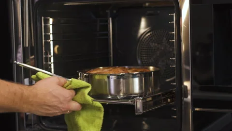 Man Chef Preparing Pastry, Opens Oven and Takes a Pie Out in Modern Kitchen. Stock-Footage 151923242