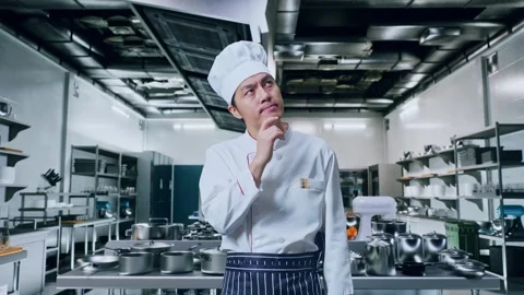 Man Chef Thinking And Looking Around Then Raising His Index Finger In Kitchen Stock Footage 273241358
