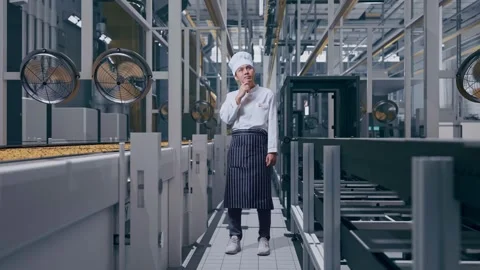 Man Chef Thinking And Looking Around Then Raising Index Finger In Cookie Factory Stock Footage 318081900
