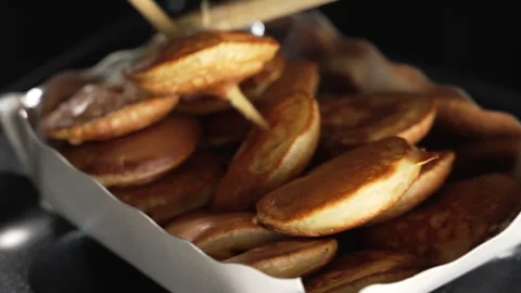 Man chef use chopsticks to pack delicious mini pancakes in the box Stock Footage 321055039