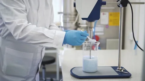 Man chemist is working with chemical solution and equipment in pharmaceutical Stockbeeldmateriaal 140416053