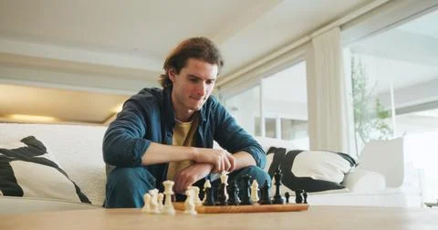 Man, chess and game on couch with strategy, solution or problem solving in Stock Photos