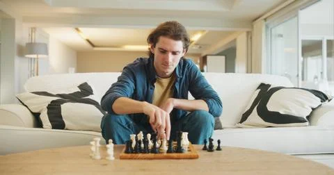 Man, chess and game on sofa with strategy, solution or problem solving in Foto stock