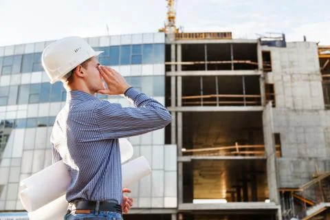 Man the chief engineer at  construction site screams of danger Stock Photos