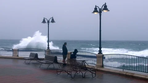 Man with children look at powerful waves at Malta coast Stock Footage 89134580