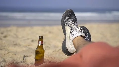 Man chilling on the beach Stock Footage 105083301