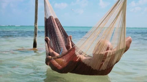 Man chilling in hammock, riviera maya  beach Stock-Footage 80974662