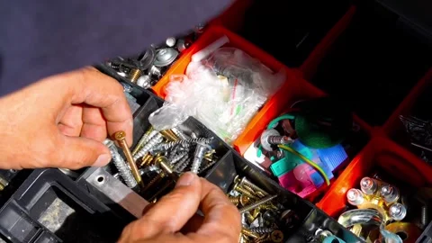 Man choose assorted Hardware and Fasteners in Storage Box Video stock 346985053