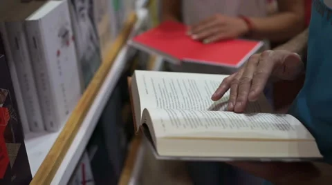 Man choose a book in a store Stock Footage 66787677