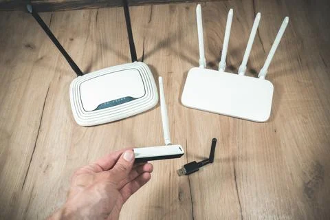 Man choose of different types of Wi-Fi routers, modern and old technology. .. 스톡 사진