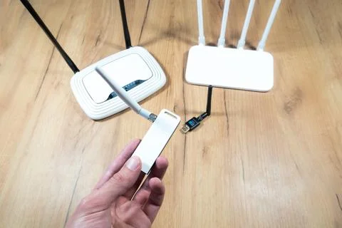 Man choose of different types of Wi-Fi routers, modern and old technology. .. Stock Photos