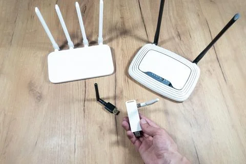 Man choose of different types of Wi-Fi routers, modern and old technology. .. Stock Photos