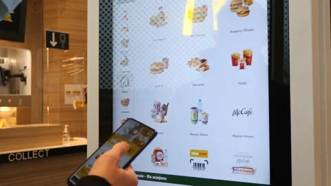 A Man choose a Menu on an electronic Screen at McDonald's Restaurant Stock Footage 141650236
