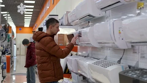 A man chooses an air conditioner. Stock Footage 170255713