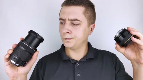 The man chooses between old and new camera lenses. The joy of receiving new equi Stock Footage 142315740