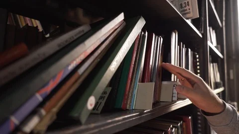 Man chooses a book in library. Reading.Relax Stock Footage 102505077