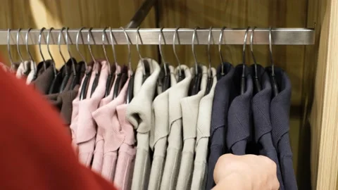 A man chooses clothes in a retail mall, close up. Stock Footage 167301287
