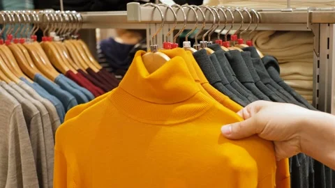 A man chooses clothes in retail mall, close up. Stock Footage 167315213